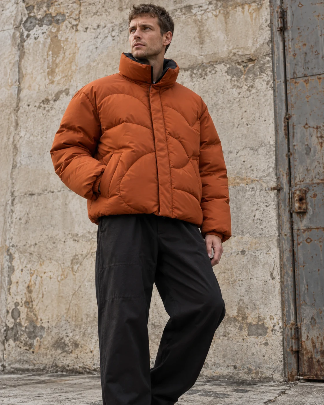 Front on-model view — Boxy Puffer Jacket in burnt orange / charcoal, AI-generated design concept