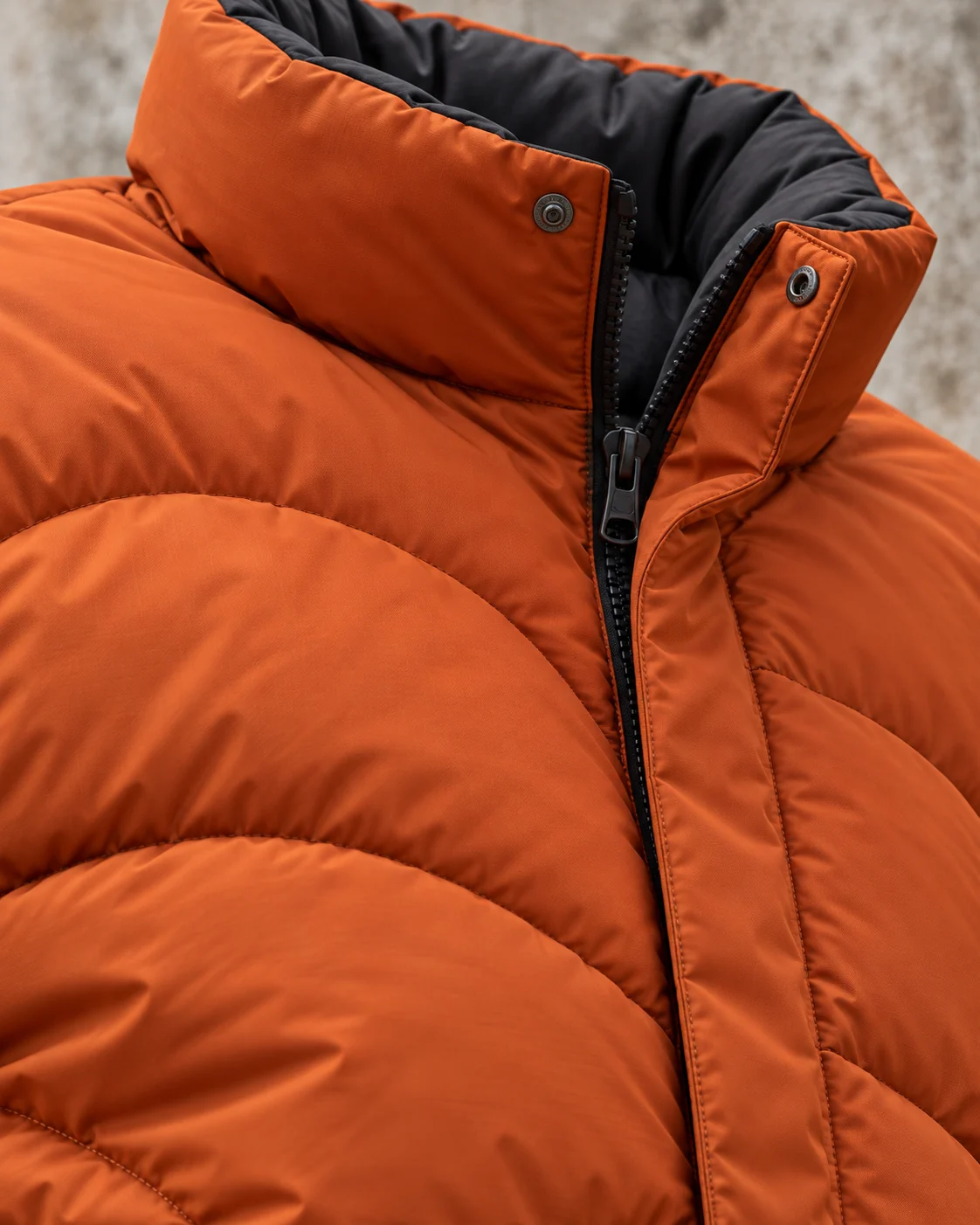 Close-up of fabric and signature construction — Boxy Puffer Jacket in burnt orange / charcoal, AI-generated design concept
