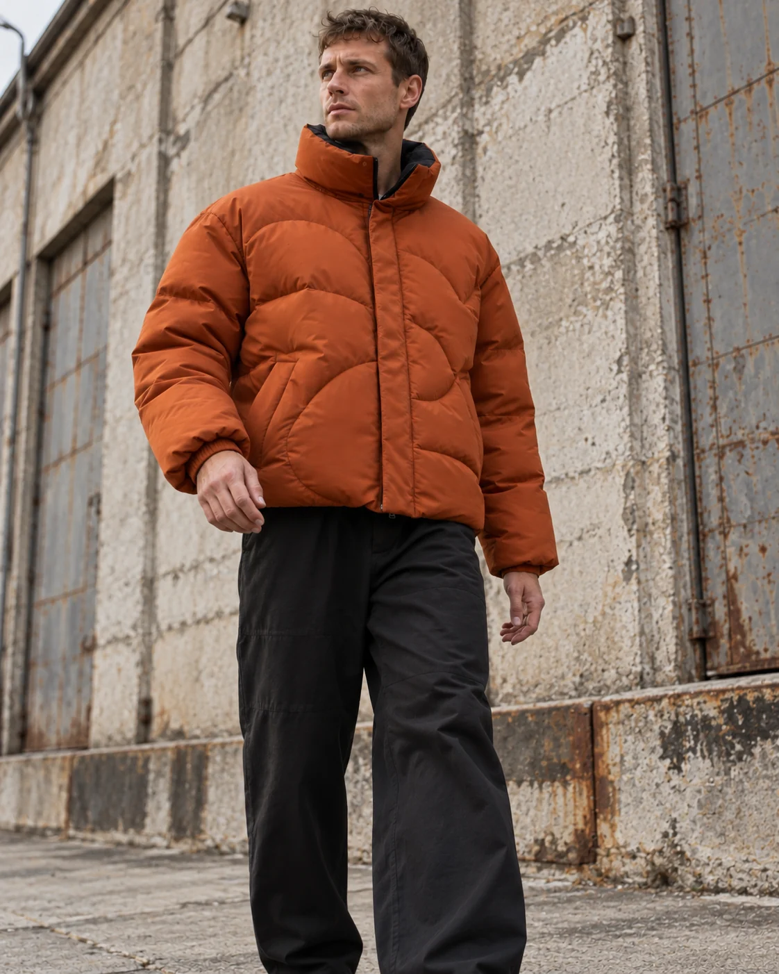 Full-body streetwear styling — Boxy Puffer Jacket in burnt orange / charcoal, AI-generated design concept