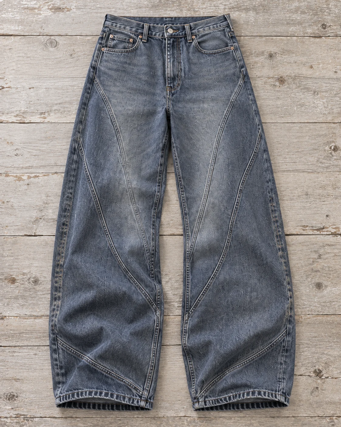 Full garment flat-lay showing the cut — Curved-Panel Jeans in slate blue / smoke grey, AI-generated design concept