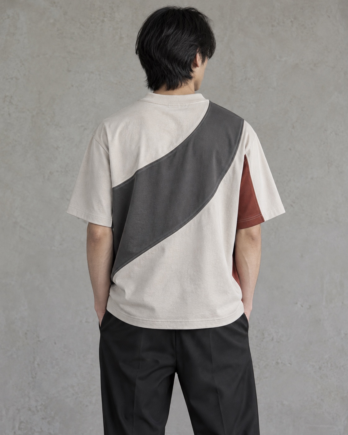 Back on-model view of the original cut-and-sew panel t-shirt concept in chalk / charcoal / clay