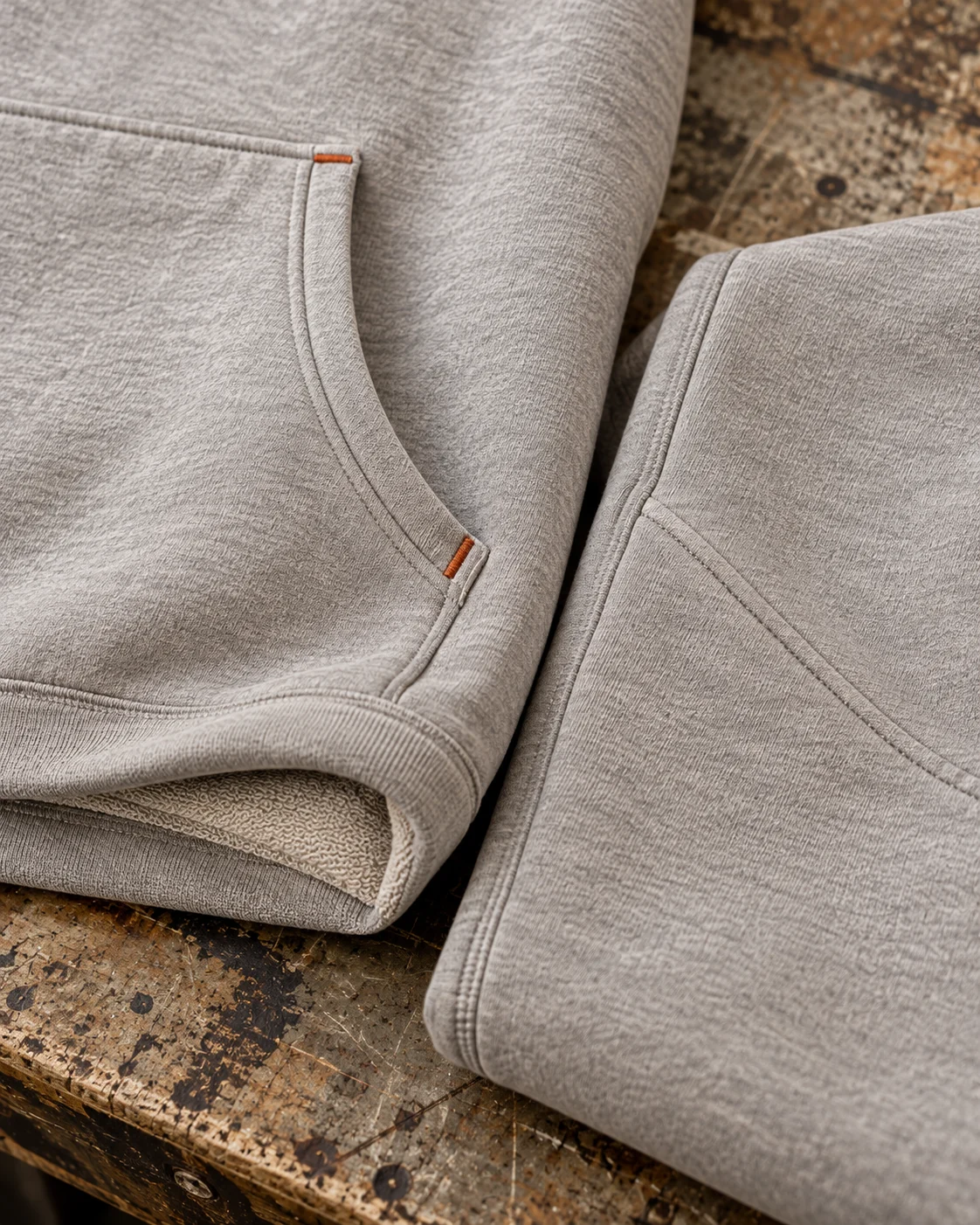 Close-up of fabric and coordinated construction — Heavyweight Hoodie & Sweatpants Set in cement grey / rust, AI-generated design concept