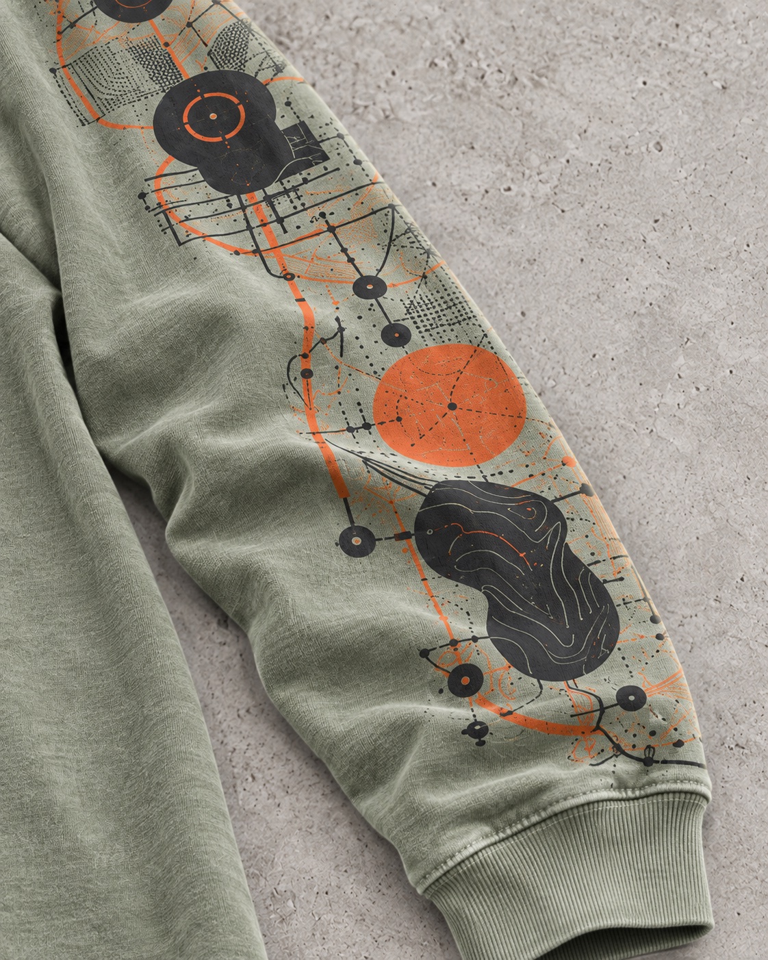 Fabric and construction close-up of the original long-sleeve sleeve-print t-shirt concept in mineral sage / burnt orange