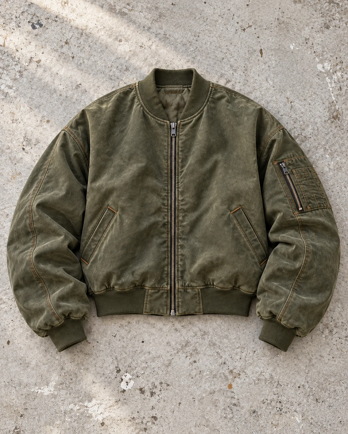 Full garment flat-lay showing the cut — Oversized Bomber Jacket in washed olive / rust, AI-generated design concept