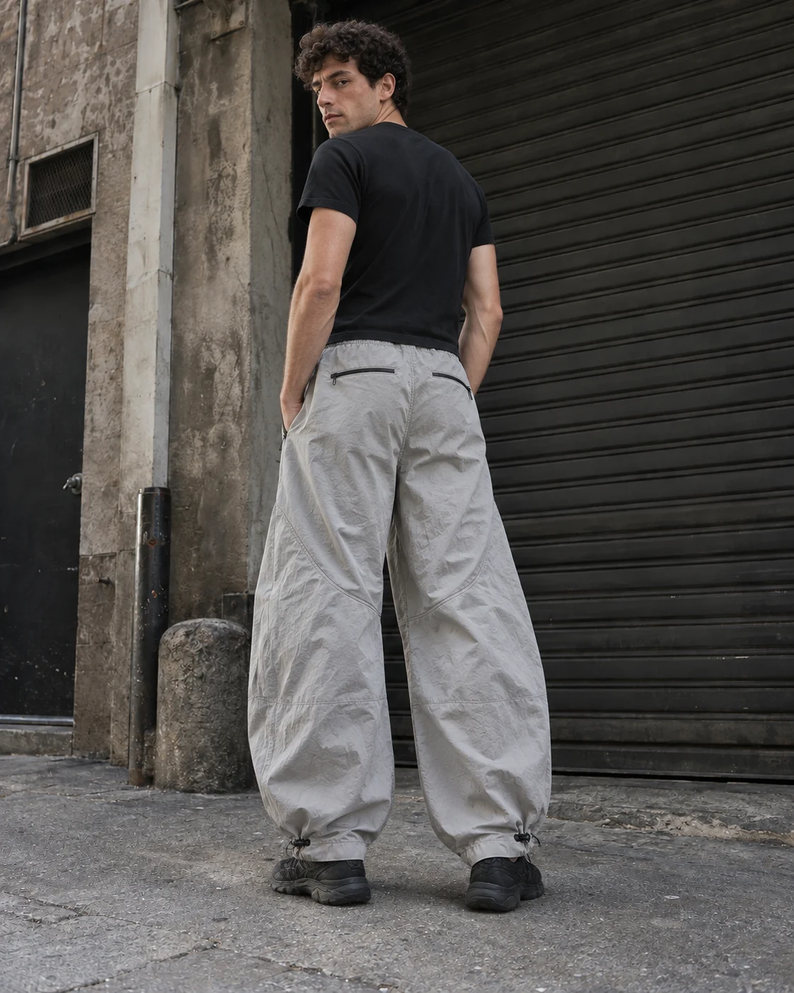 Distinct back design on the same model — Parachute Pants in stone grey / charcoal, AI-generated design concept
